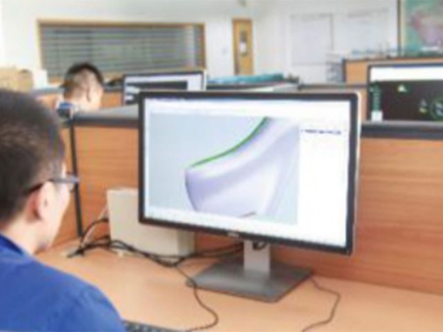 A developer refining a 3D model of a shoe last on a large monitor.